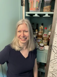 Elizabeth standing in front of an organized pantry